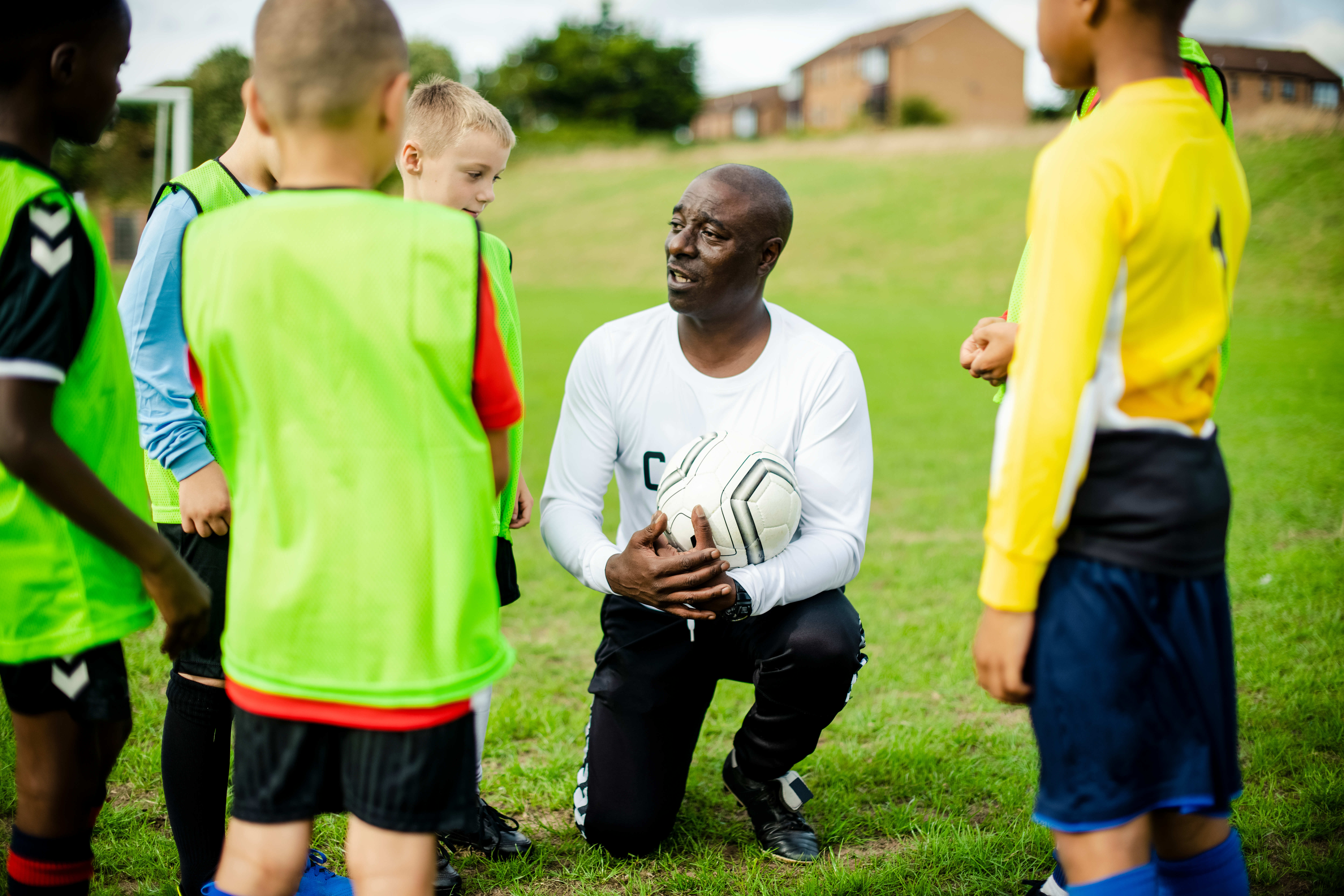 Football coach instructing his students